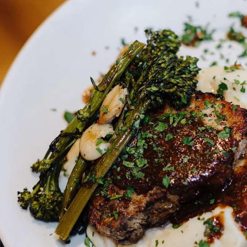 Pork chop with mashed potato and broccolini